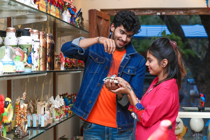 Family selecting memorable souvenirs at Ramoji Film City gift shop Family selecting memorable souvenirs at Ramoji Film City gift shop